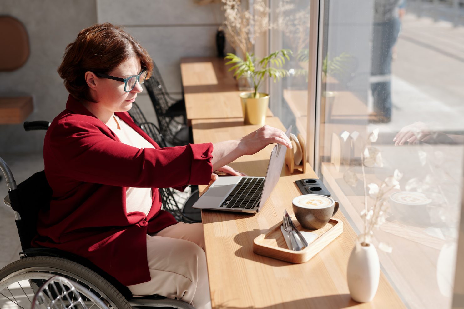 A woman in wheelchair using a laptop