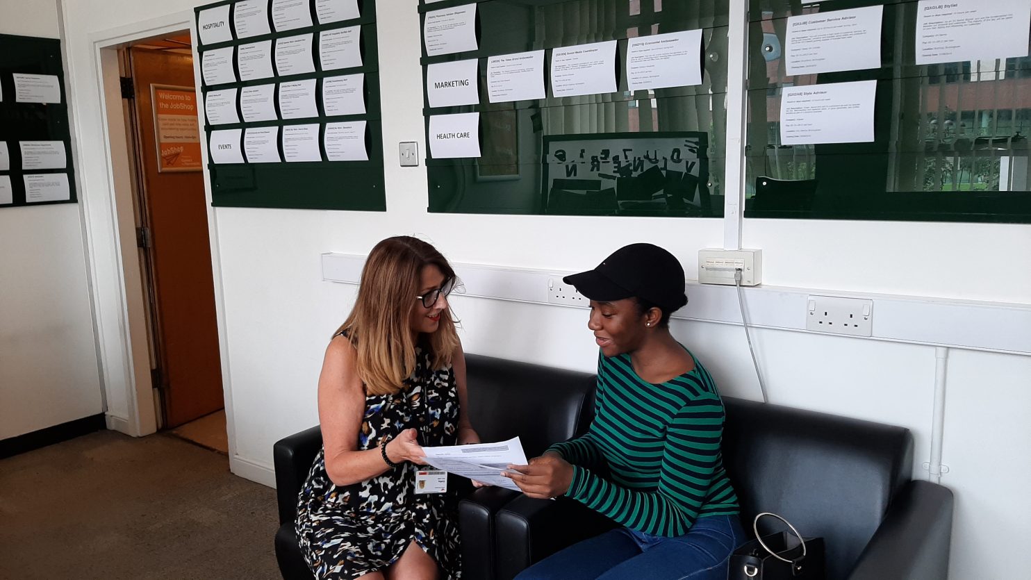 A student getting CV advice from Cathy, the JobShop manager